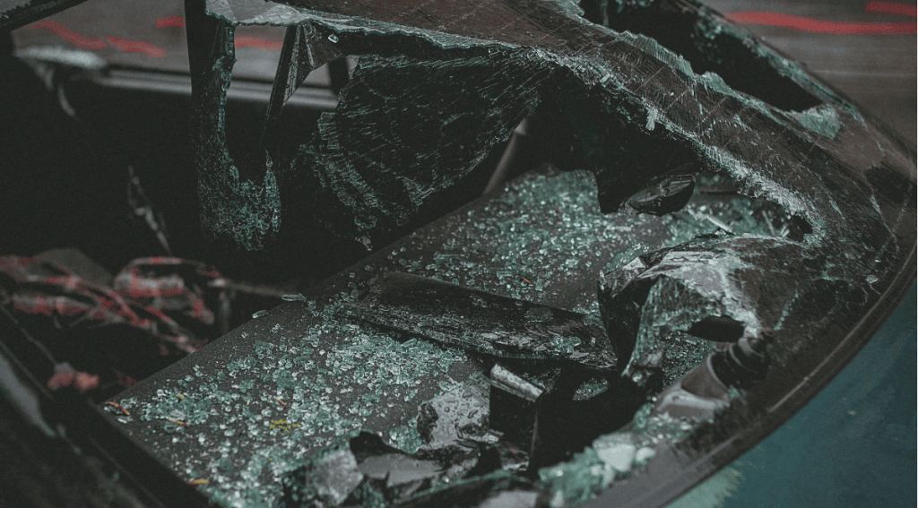 Car with its windshield completely damaged in a crash.