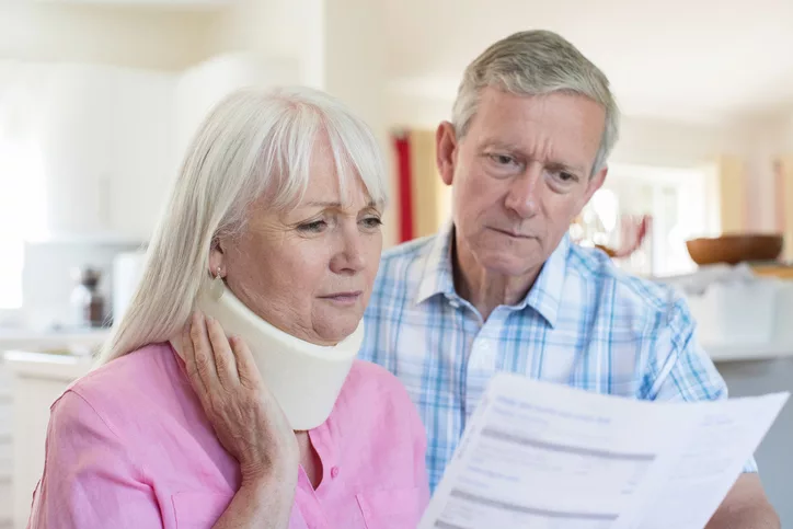 Mature Couple Reading Letter About Wife's Injury