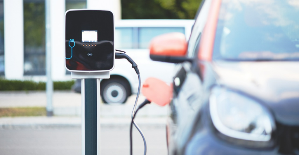 Electric car connected to a charging dock.